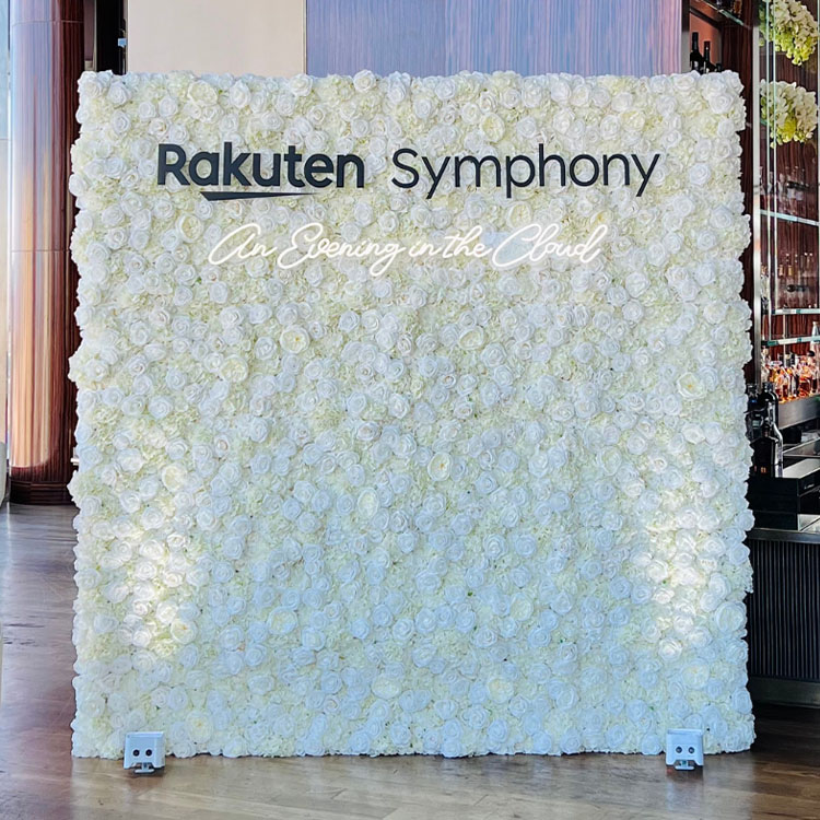 White and Cream Flower Wall Rental for a corporate event with a custom acrylic sign and custom neon sign.